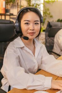 Businesswoman with headset working at desk in modern office.